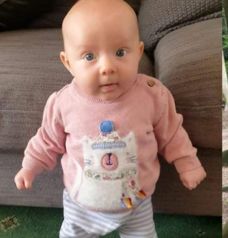 Worlds strongest baby stands at 8 weeks old 