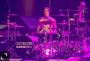 Travis Barker has come back to stage on Wednesday night, playing the drums again in his first public performance since being hospitalized in late June for a "life-threatening" pancreatitis