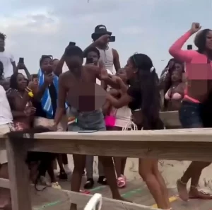 Women fighting at spring break outing at US beach.