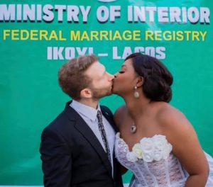 Nollywood actress, Etinosa Idemudia has tied the knot with her Caucasian lover, joining the ranks of newlywed couples. This comes after the actress recently unveiled her Caucasian partner on Instagram, seeking well wishes as she embarks on her new journey. In a recent Instagram story, Etinosa Idemudia revealed her relationship status, confirming she's officially tied the knot. Her announcement was accompanied by a photo showing their intimate court wedding, with the couple sharing a romantic kiss The caption reads,"God did". Meanwhile, the announcement has sparked an outpouring of congratulatory messages from fans and industry colleagues, extending warm wishes for their marital union.